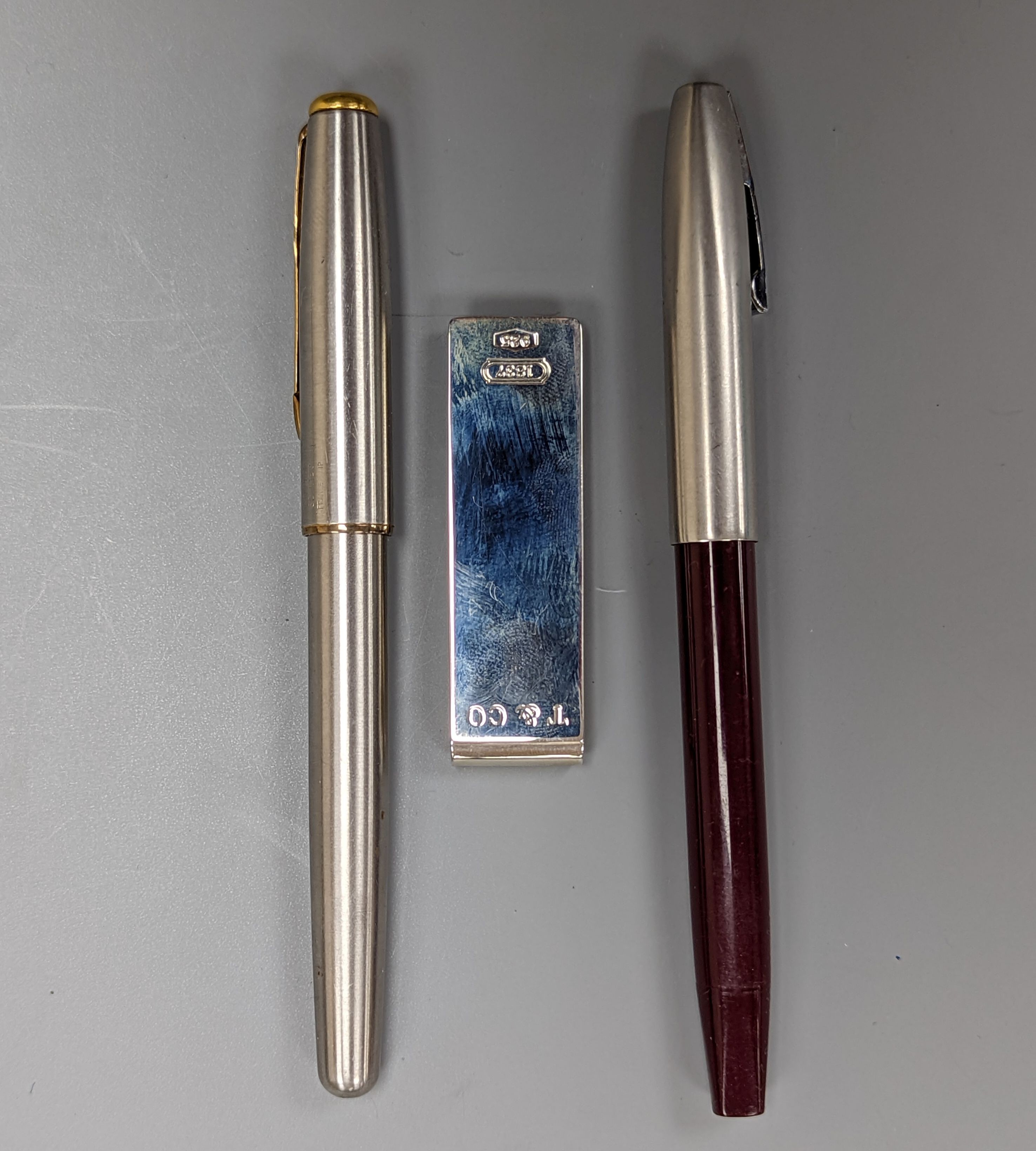 A boxed Tiffany & Co sterling silver money clip, and Parker and Sheffer fountain pens.